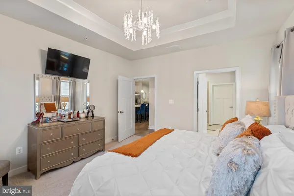 a bedroom with a bed and a chandelier