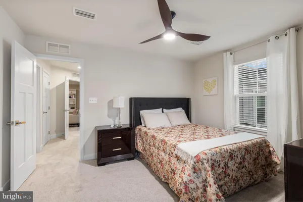 a bedroom with a bed and a large mirror