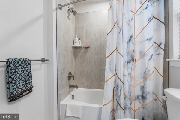 a bathroom with a bathtub and shower