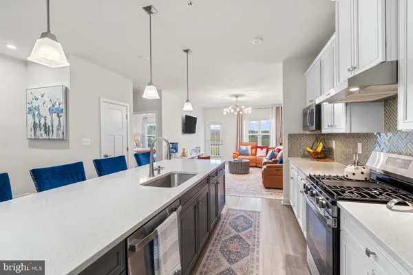 a kitchen with stove a sink and a refrigerator