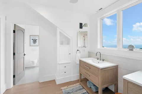 a view of a bedroom with furniture and windows