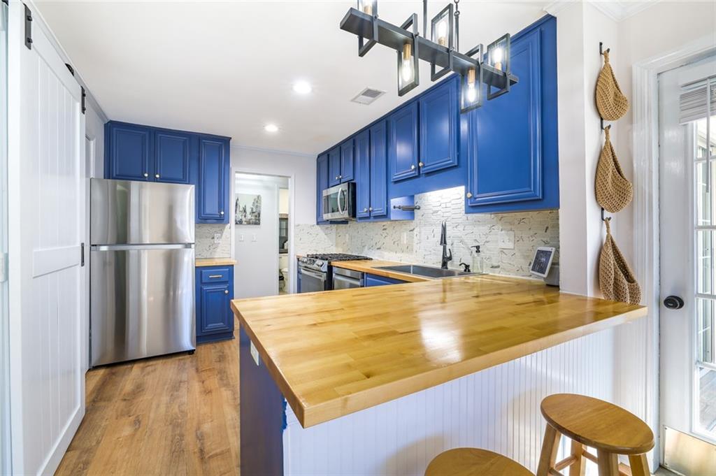 404 Countryside Place Smyrna, GA 30080 - Photo 11 of 36 a kitchen with refrigerator and chairs