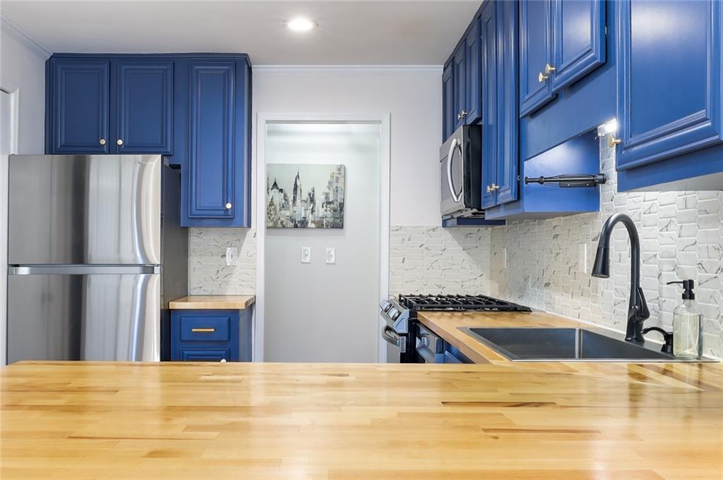 404 Countryside Place Smyrna, GA 30080 - Photo 12 of 36 a kitchen with granite countertop a refrigerator and a sink