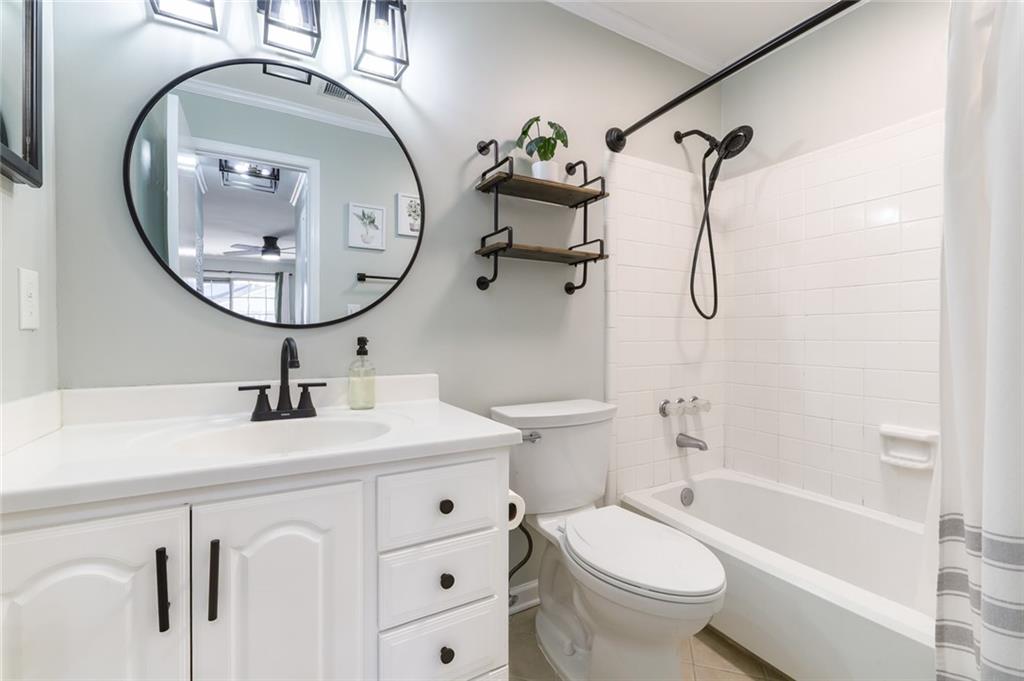 404 Countryside Place Smyrna, GA 30080 - Photo 21 of 36 a bathroom with a sink a toilet and a mirror