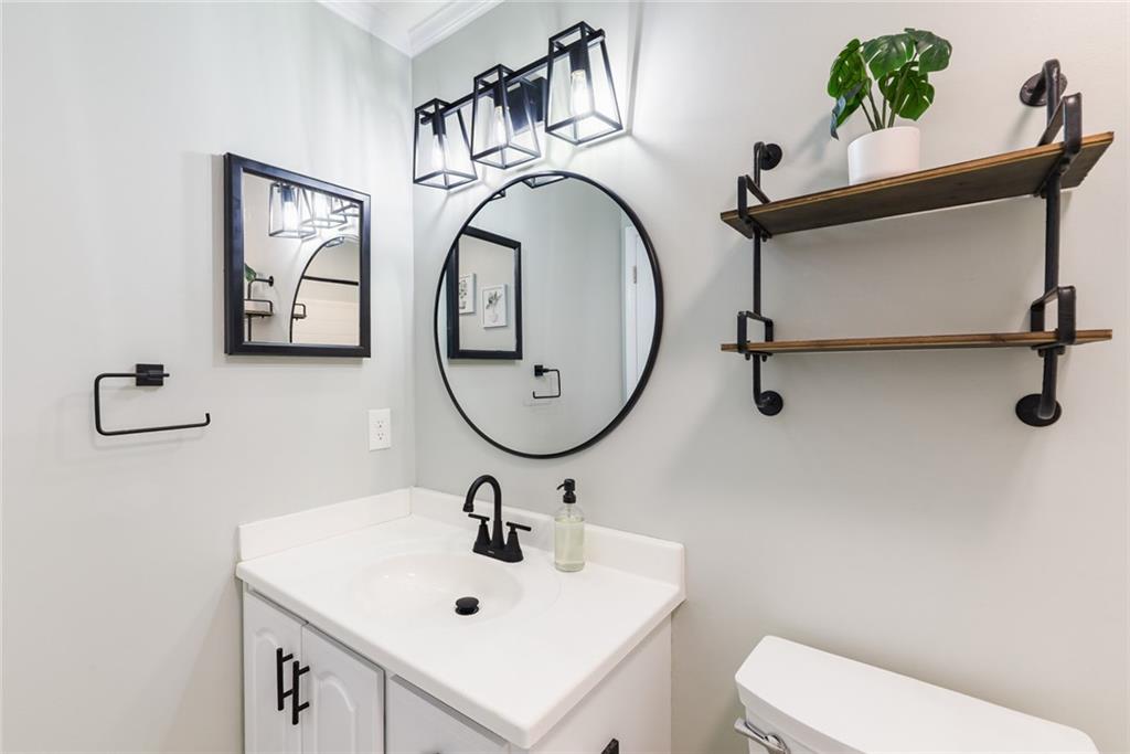 404 Countryside Place Smyrna, GA 30080 - Photo 22 of 36 a bathroom with a toilet a sink and mirror