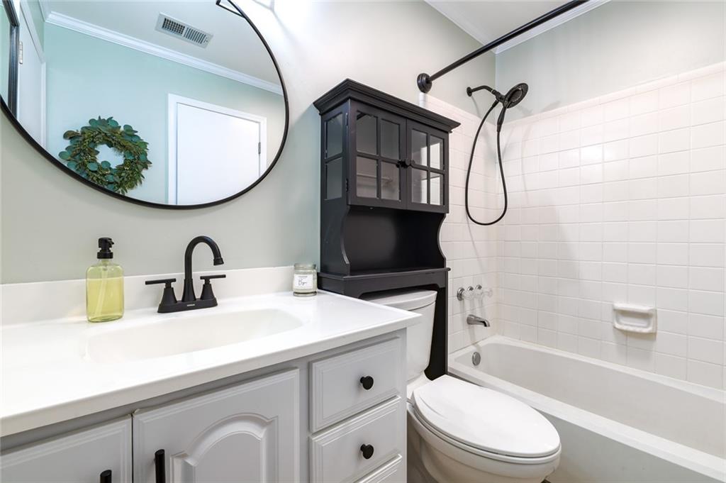 404 Countryside Place Smyrna, GA 30080 - Photo 26 of 36 a bathroom with a sink a toilet and a mirror