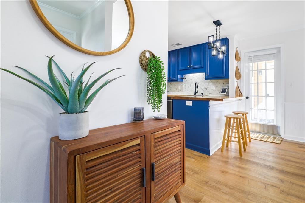 404 Countryside Place Smyrna, GA 30080 - Photo 7 of 36 a kitchen with a table chairs potted plants and wooden floor