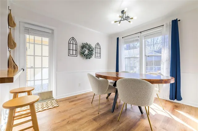 a dining room with wooden floor and a window