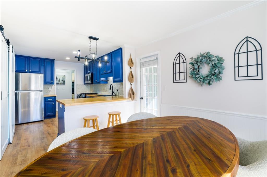 404 Countryside Place Smyrna, GA 30080 - Photo 9 of 36 a large kitchen with kitchen island a refrigerator wooden floor and window
