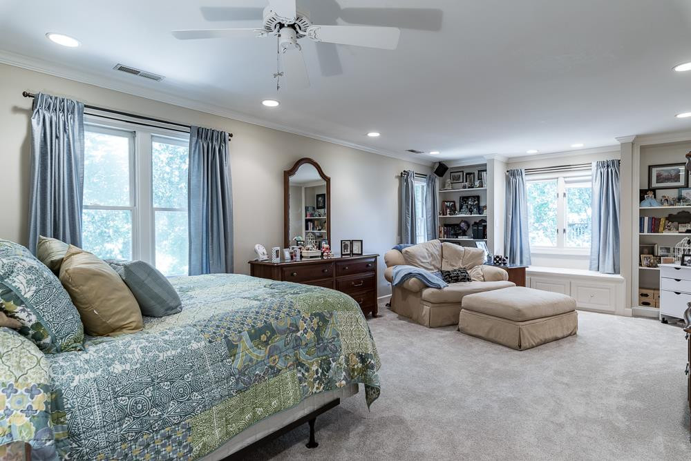 1905 Russell Drive Raleigh, NC 27612 - Photo 19 of 30 Bedroom 4 or 2nd floor bonus room, crown moulding, ceiling fan, direct lighting, window seat, bookshelves, private bath, walk-in closet, fresh paint and new carpet floors. Bedroom