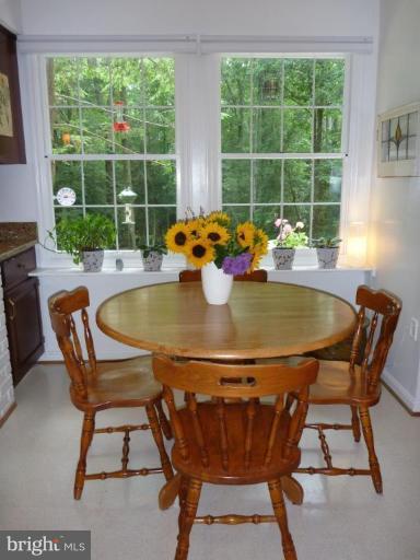 11615 Foxclove Road Reston, VA 20191 - Photo 6 of 30 a view of a dining table and chairs in the porch