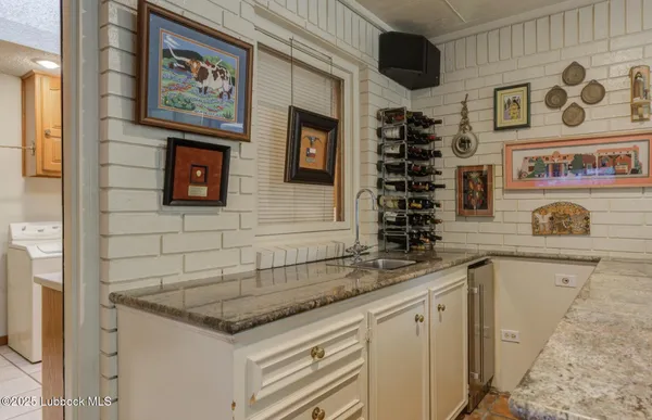 a kitchen with stainless steel appliances granite countertop a sink and cabinets