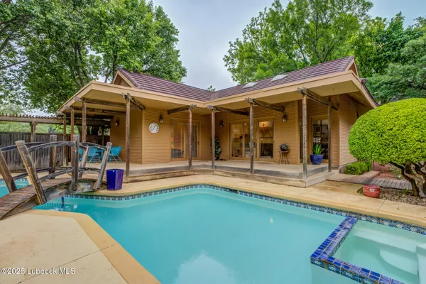 an outdoor view of house with swimming pool and porch