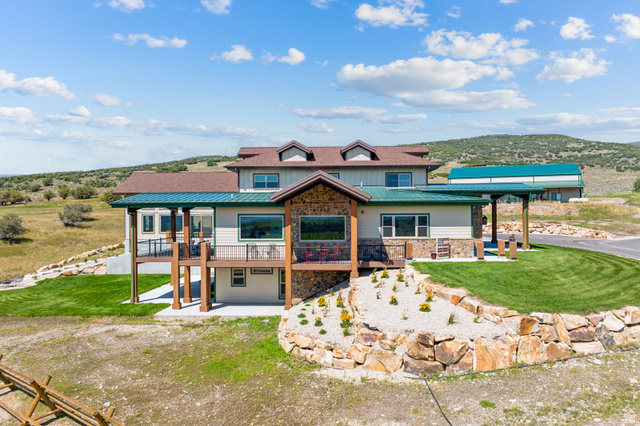 6117 North Rocky Ridge Road Peoa, UT 84061 - Photo 5 of 82 Stone and siding exterior with a multi-level design
