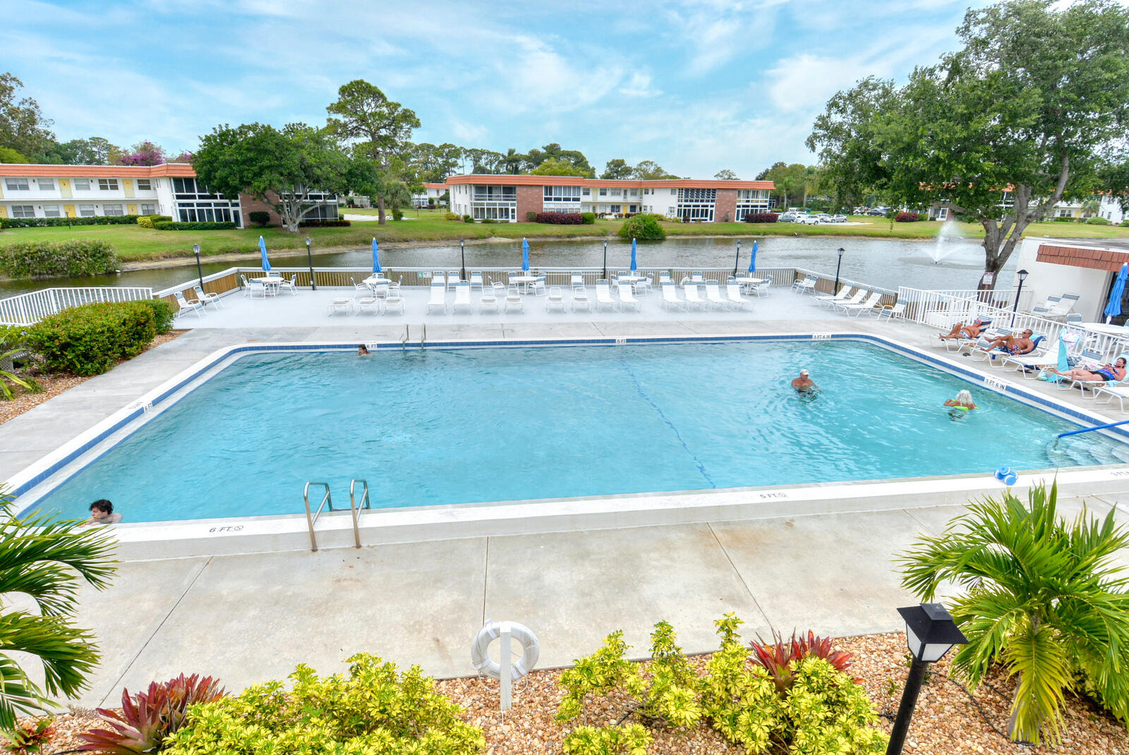 1225 Northwest 21st Street, Unit 203 Stuart, FL 34994 - Photo 41 of 44 a view of a swimming pool with a yard