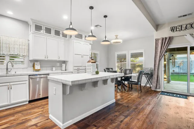 a kitchen with stainless steel appliances a stove a microwave a sink and cabinets