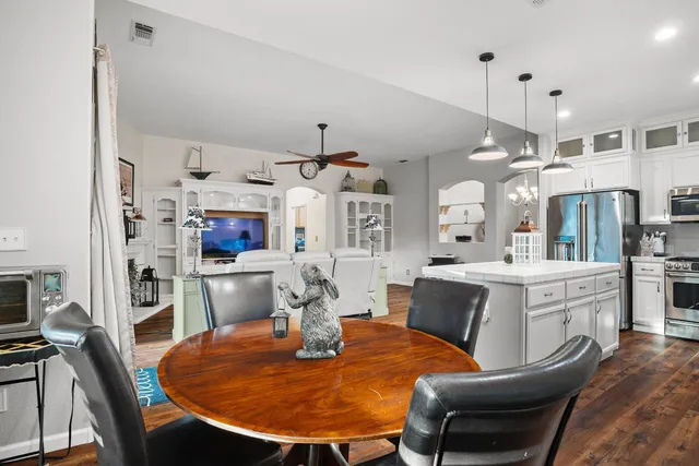 a large kitchen with sink cabinets and wooden floor