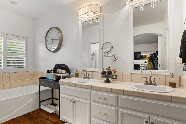 a bathroom with a double vanity sink and a mirror