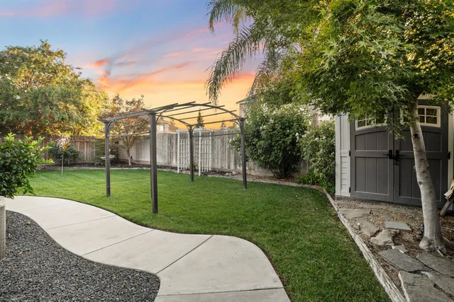 a backyard of a house with table and chairs
