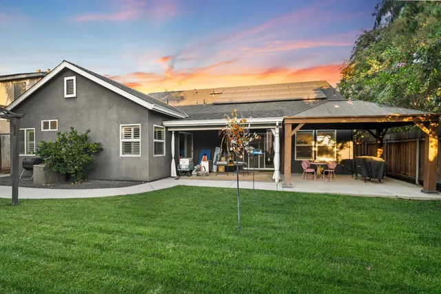 a view of a house with backyard porch and sitting area