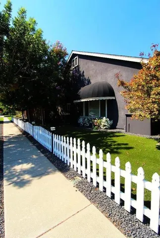 a view of a house with a yard and sitting area