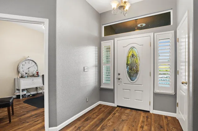 a view of a entryway door with wooden floor