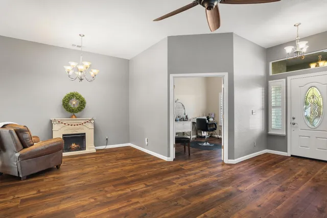 a living room with furniture and a chandelier