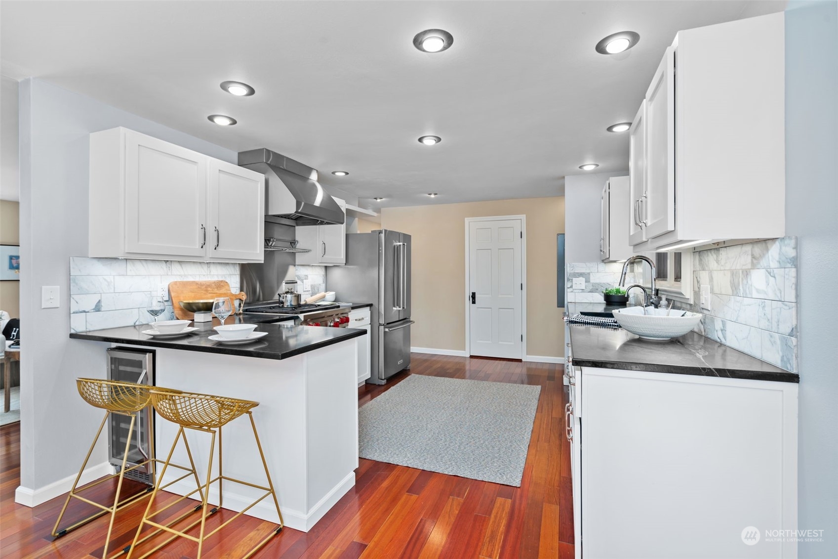 1313 North 28th Street Renton, WA 98056 - Photo 12 of 35 a kitchen with stainless steel appliances granite countertop a sink stove and refrigerator