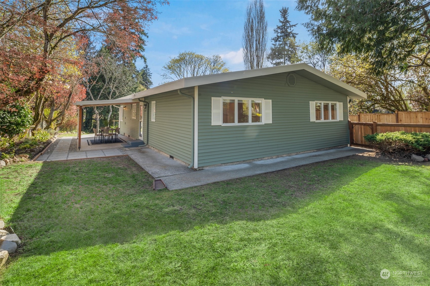 1313 North 28th Street Renton, WA 98056 - Photo 2 of 35 a backyard of a house with potted plants and large tree
