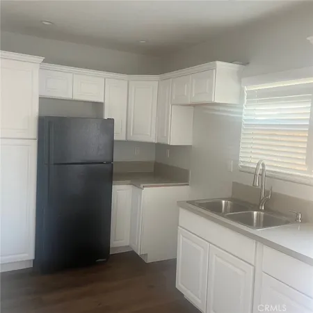 a kitchen with a refrigerator and a sink