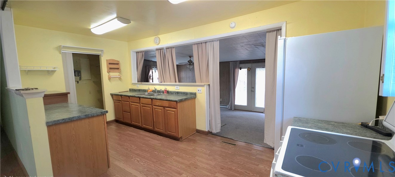 2071 Wickham Road Bumpass, VA 23024 - Photo 2 of 4 a kitchen with stainless steel appliances granite countertop a refrigerator and a stove top oven