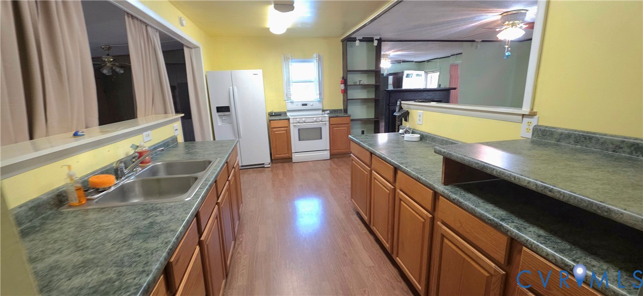 2071 Wickham Road Bumpass, VA 23024 - Photo 3 of 4 a kitchen with stainless steel appliances granite countertop sink stove and refrigerator
