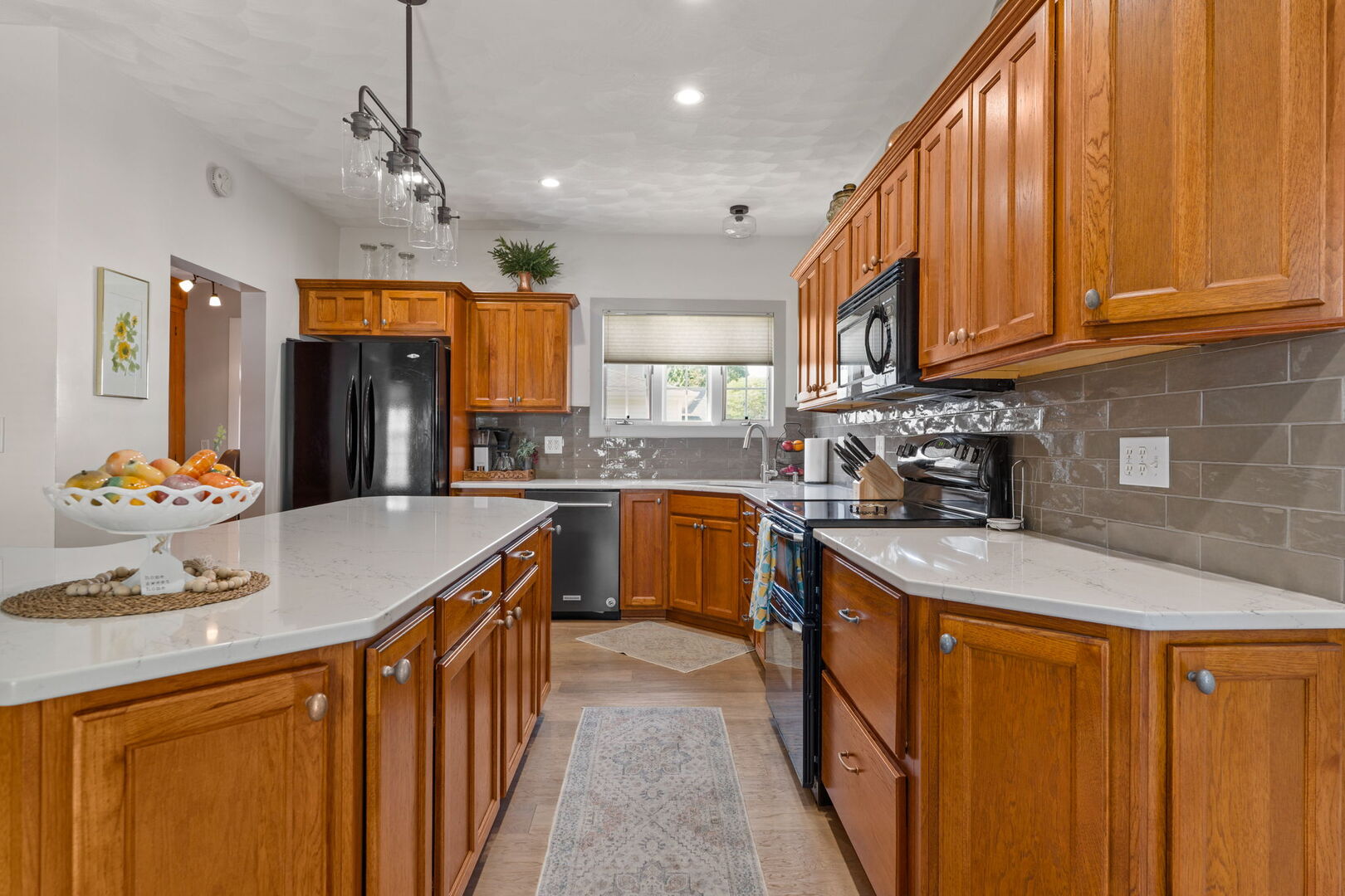417 North State Street Geneseo, IL 61254 - Photo 7 of 51 a kitchen with stainless steel appliances granite countertop wooden cabinets a sink dishwasher a stove and a refrigerator