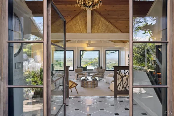 a view of a dining room with furniture wooden floor and a chandelier