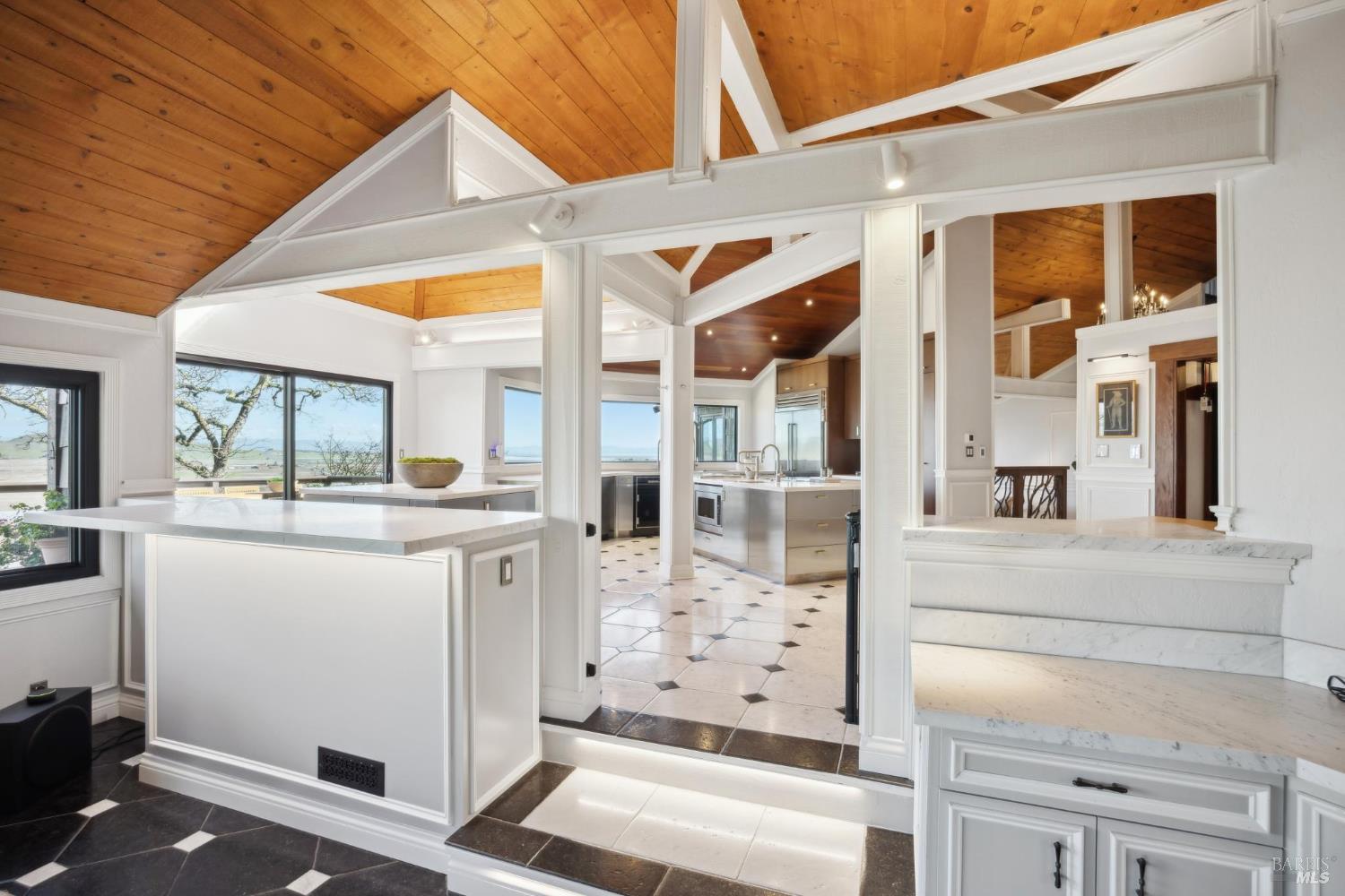 160 Crest Road Novato, CA 94945 - Photo 46 of 85 a kitchen with stainless steel appliances kitchen island granite countertop a refrigerator a stove and white cabinets with wooden floor