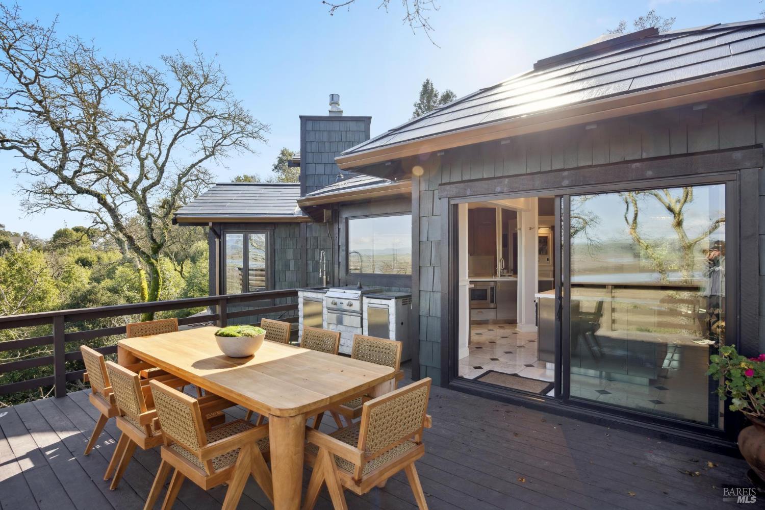 160 Crest Road Novato, CA 94945 - Photo 80 of 85 a view of a patio with table and chairs with wooden floor and fence and a floor to ceiling window