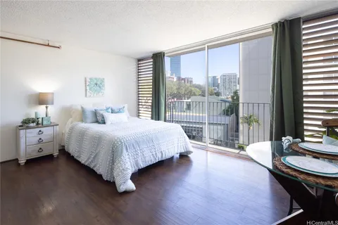 a spacious bedroom with a large bed and a large window