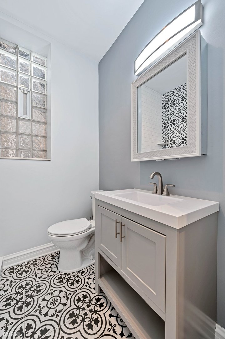 843 West Newport Avenue, Unit 2 Chicago, IL 60657 - Photo 12 of 26 a bathroom with a toilet sink and mirror