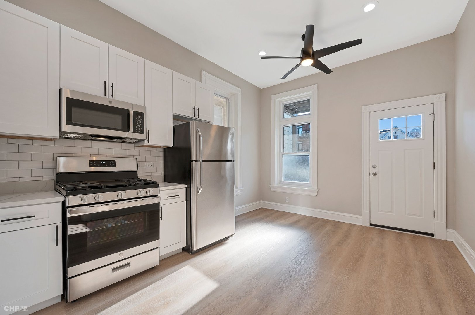 843 West Newport Avenue, Unit 2 Chicago, IL 60657 - Photo 15 of 26 a kitchen with stainless steel appliances a stove a refrigerator and a microwave
