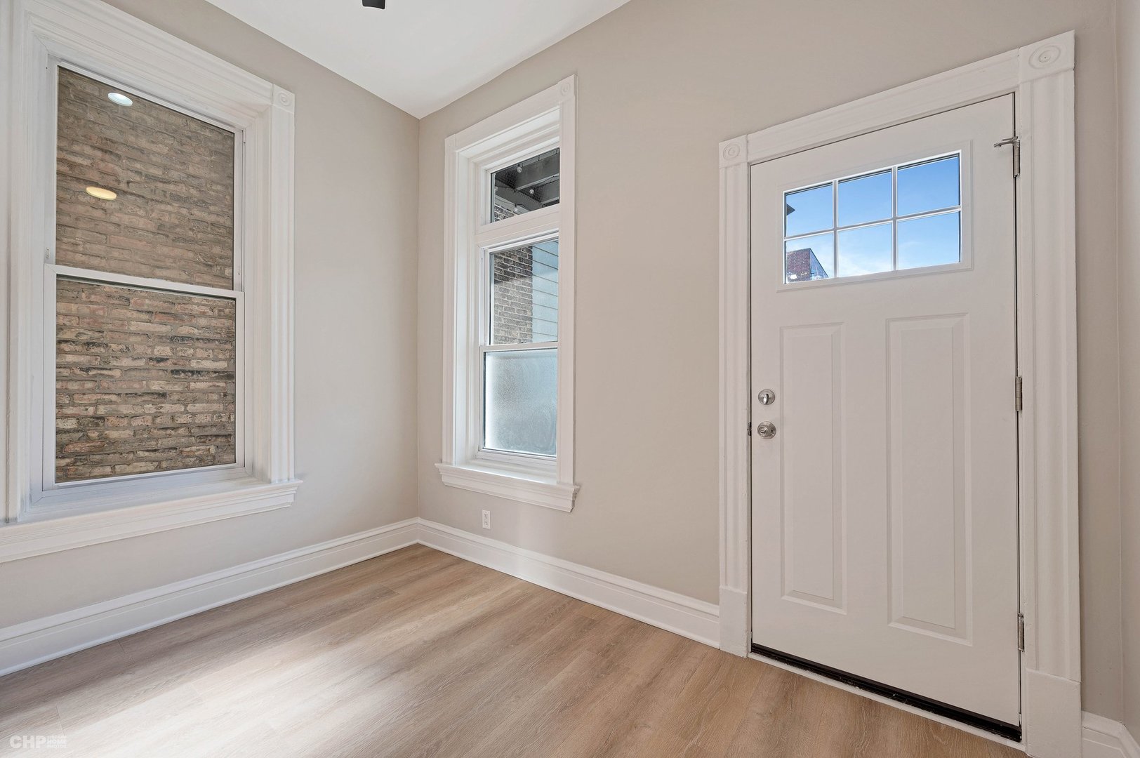 843 West Newport Avenue, Unit 2 Chicago, IL 60657 - Photo 17 of 26 a view of an empty room with wooden floor and a window