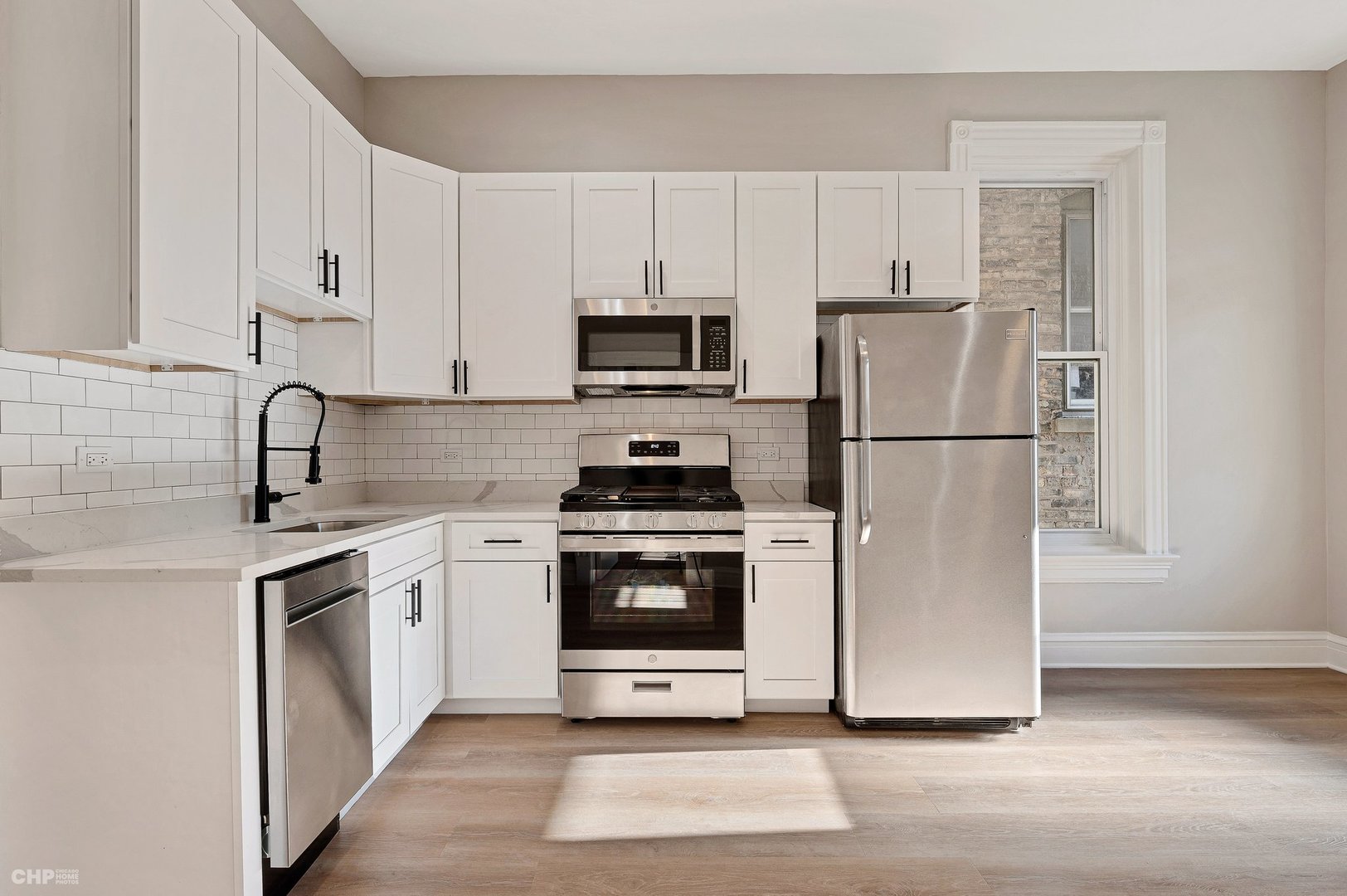 843 West Newport Avenue, Unit 2 Chicago, IL 60657 - Photo 18 of 26 a kitchen with cabinets stainless steel appliances and a counter space