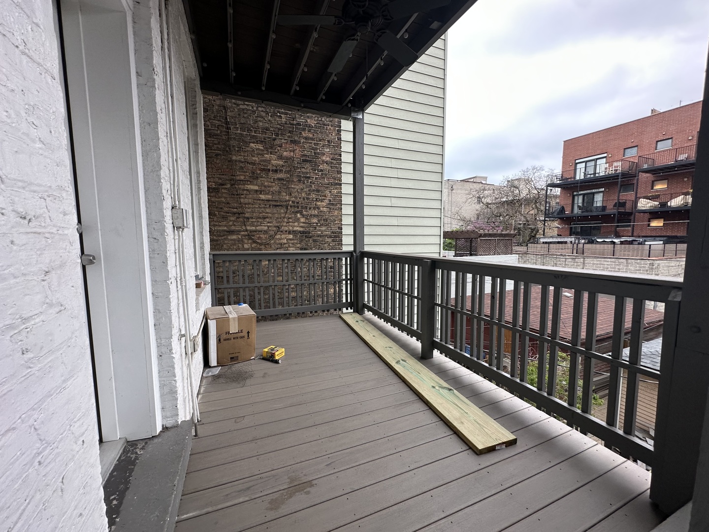 843 West Newport Avenue, Unit 2 Chicago, IL 60657 - Photo 24 of 26 a balcony with wooden floor