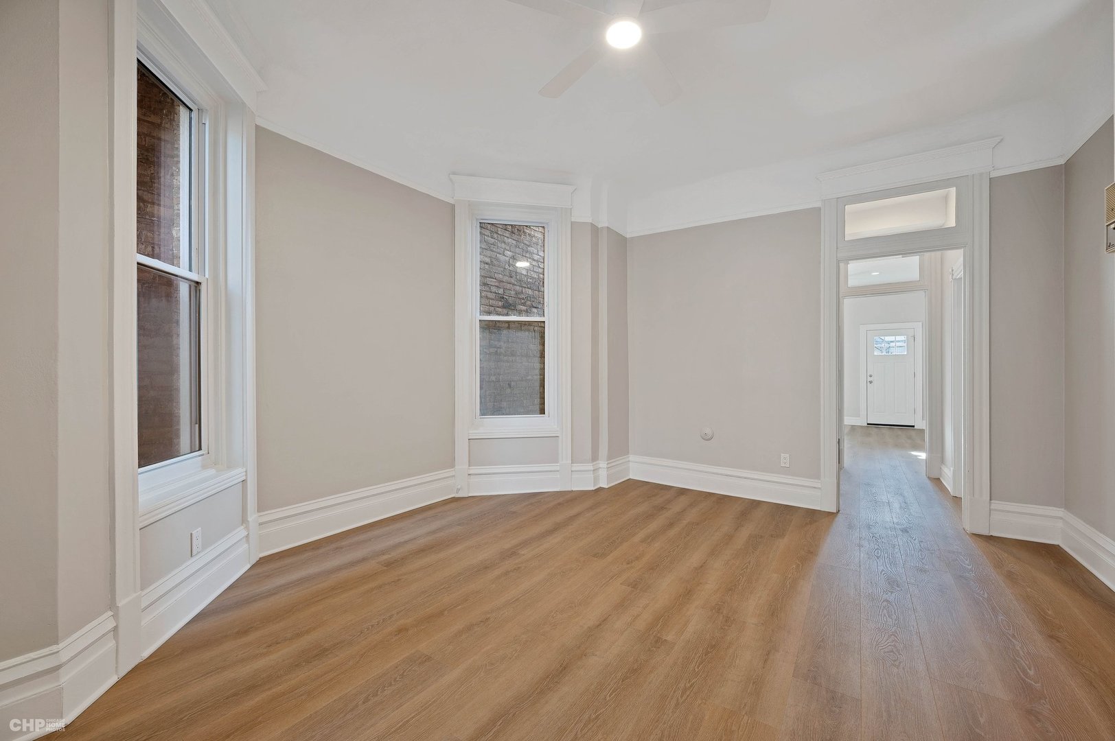 843 West Newport Avenue, Unit 2 Chicago, IL 60657 - Photo 5 of 26 a view of an empty room with wooden floor and a window