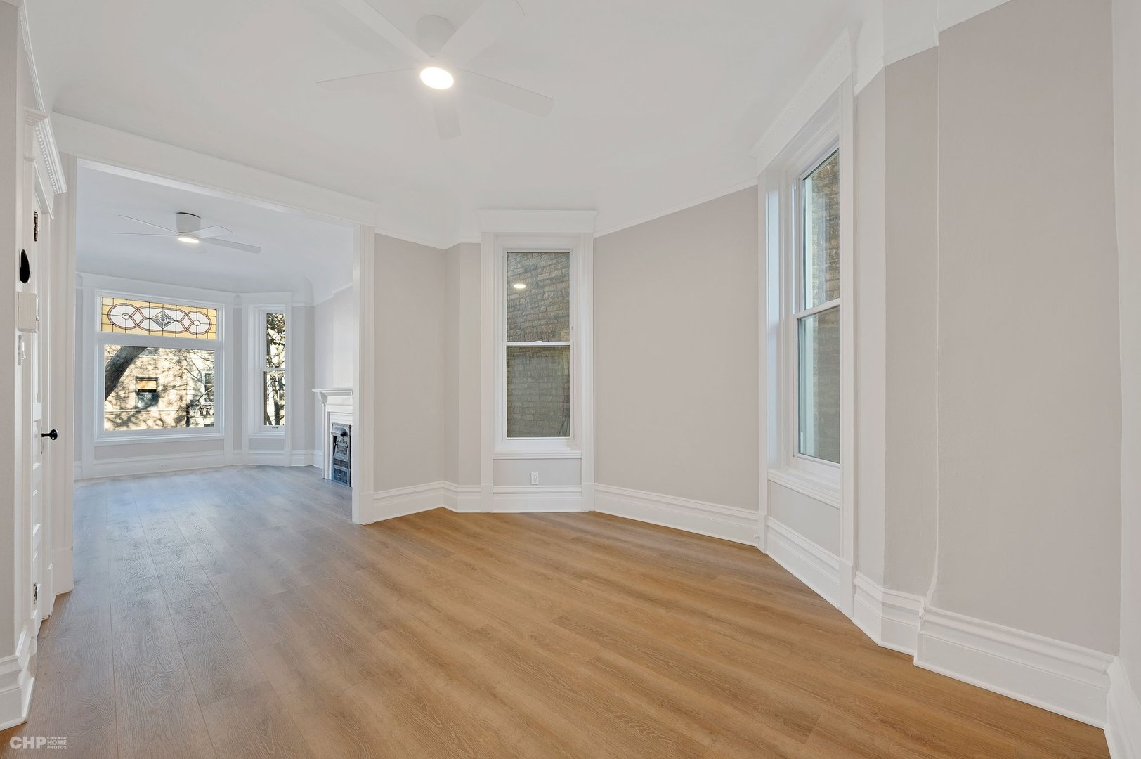 843 West Newport Avenue, Unit 2 Chicago, IL 60657 - Photo 7 of 26 wooden floor in an empty room with a window