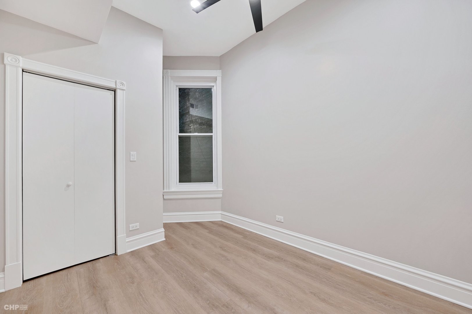 843 West Newport Avenue, Unit 2 Chicago, IL 60657 - Photo 10 of 26 a view of an empty room with wooden floor and closet
