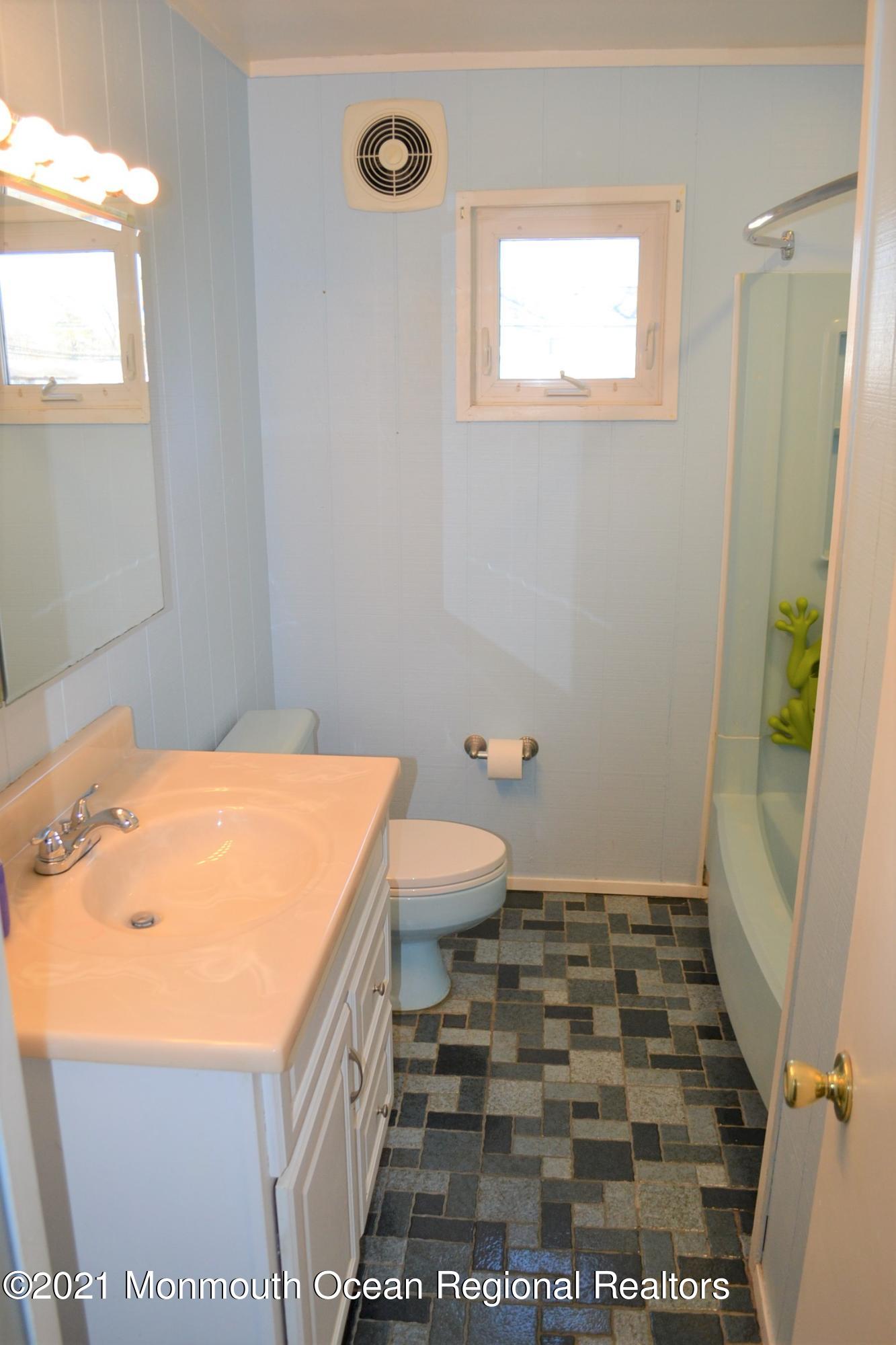 18 Castle Avenue Jackson, NJ 08527 - Photo 12 of 19 a bathroom with a sink a toilet and a window