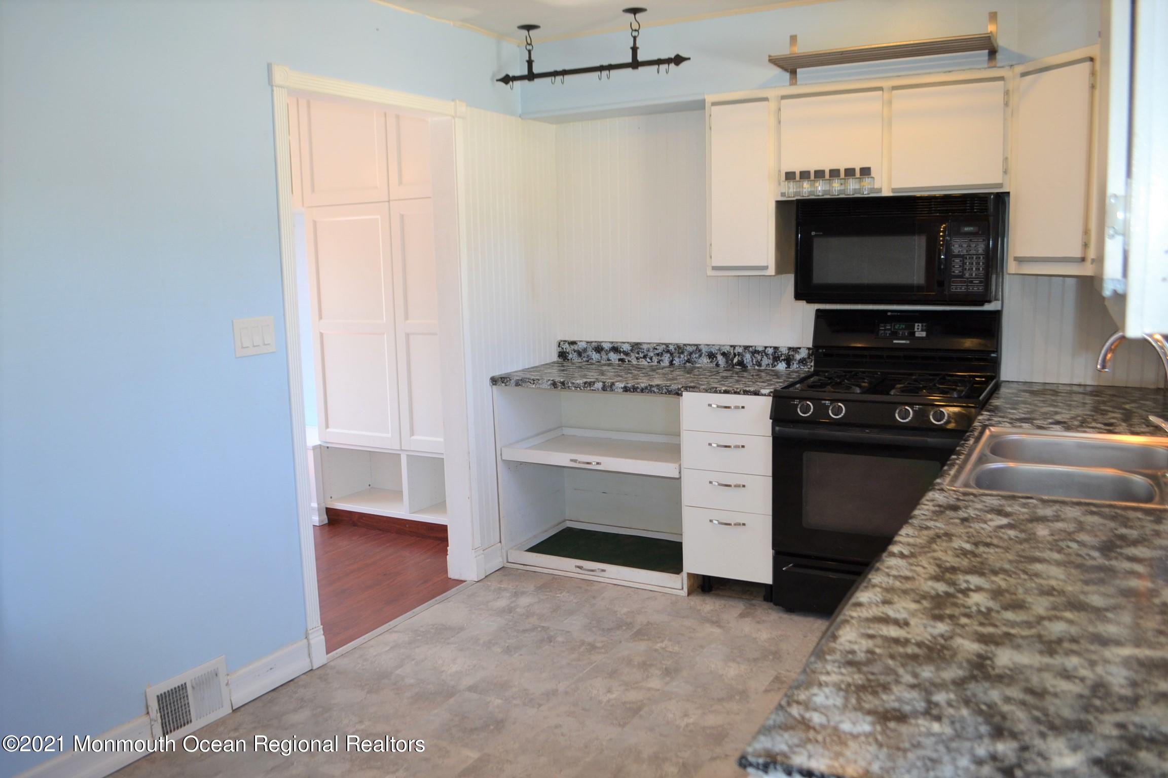 18 Castle Avenue Jackson, NJ 08527 - Photo 4 of 19 a kitchen with a stove and a microwave