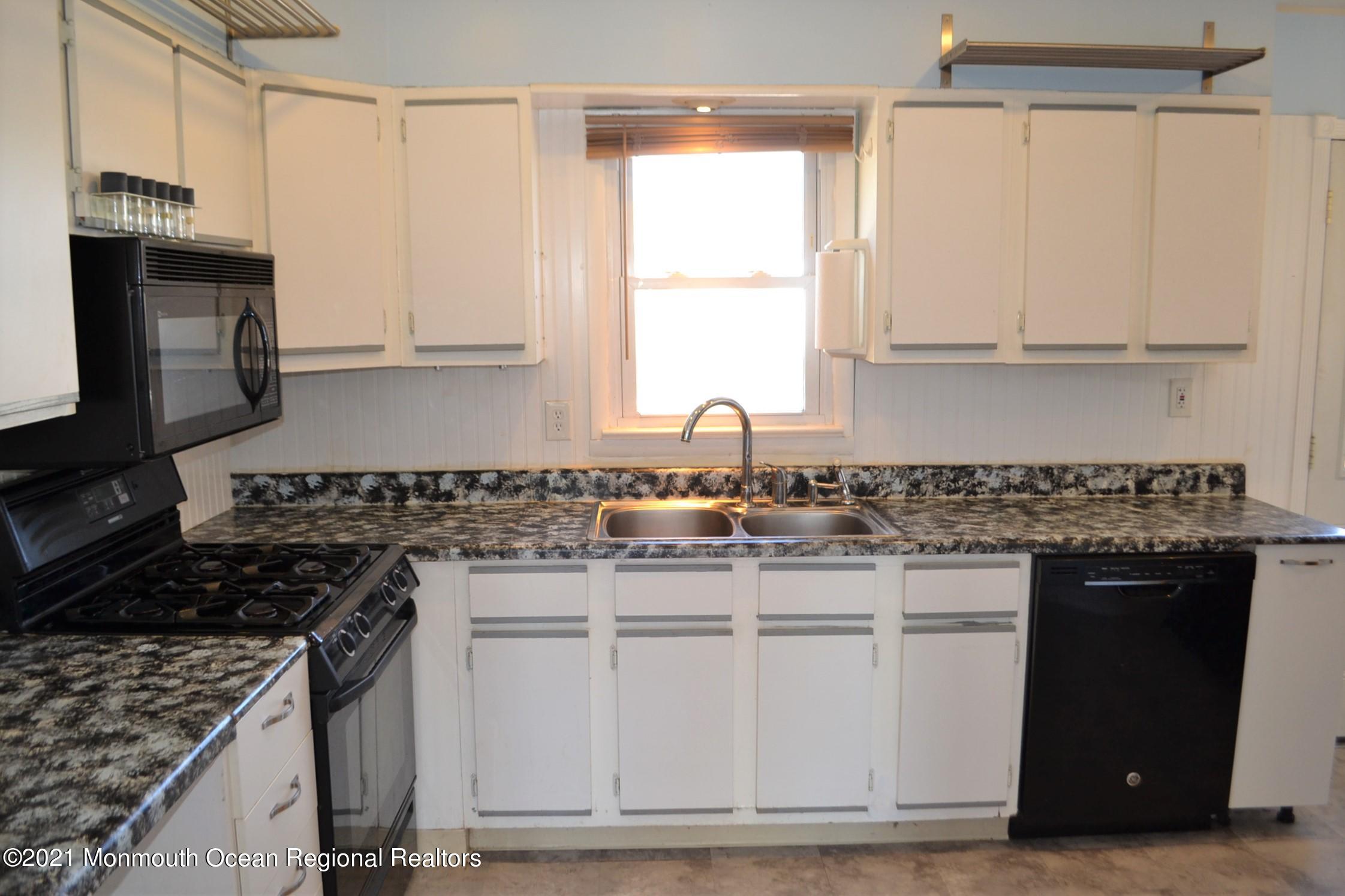18 Castle Avenue Jackson, NJ 08527 - Photo 5 of 19 a kitchen with granite countertop a sink stove and refrigerator