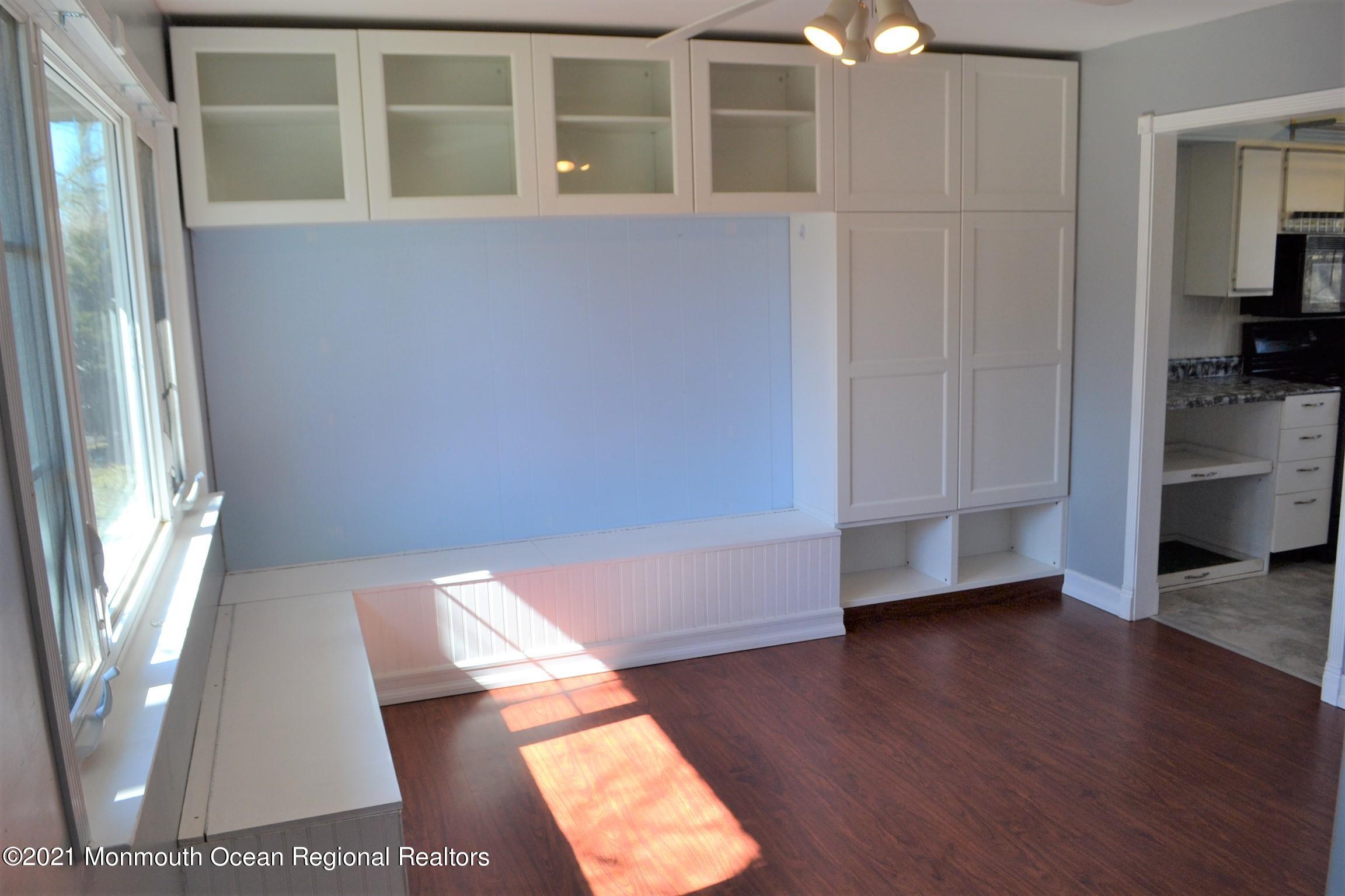 18 Castle Avenue Jackson, NJ 08527 - Photo 7 of 19 a view of an empty room with wooden floor and a window