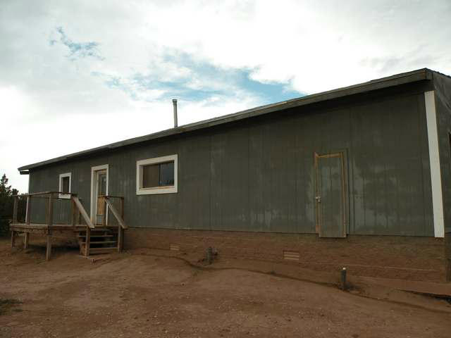 4674 Damron Valley Road Snowflake, AZ 85937 - Photo 18 of 19 a backyard of a house with barbeque oven table and chairs